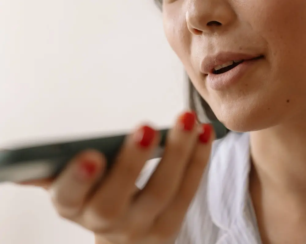 A shopper asking a voice assistant on her phone