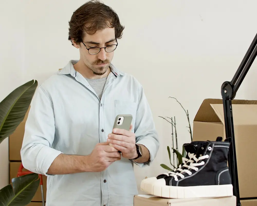 A shop owner photographing a product for the catalogue
